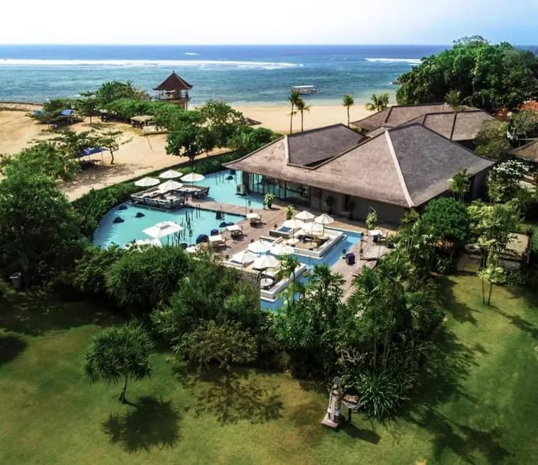 Resort set among trees beside the beach at Nusa Dua, Bali