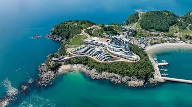 SONO island resort on a turquoise bay, seen from the air