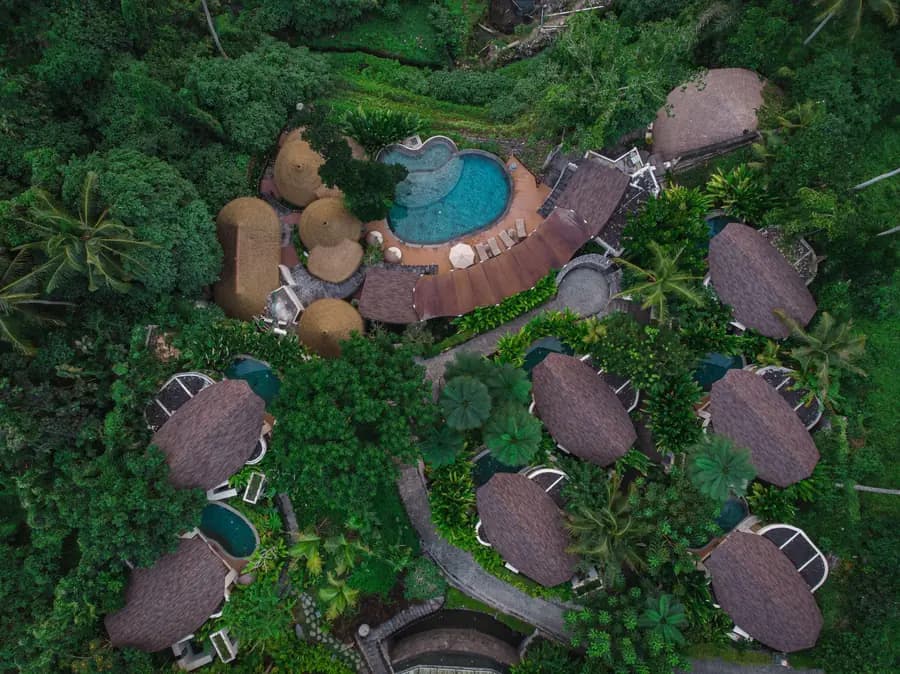 Aerial view of private pool villas in tropical forest