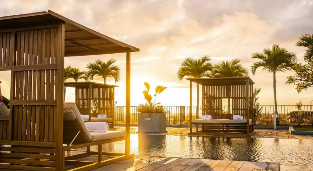Beachfront cabana at sunset beneath palms