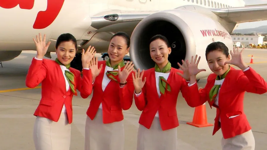 T’way Air cabin crew beside an aircraft